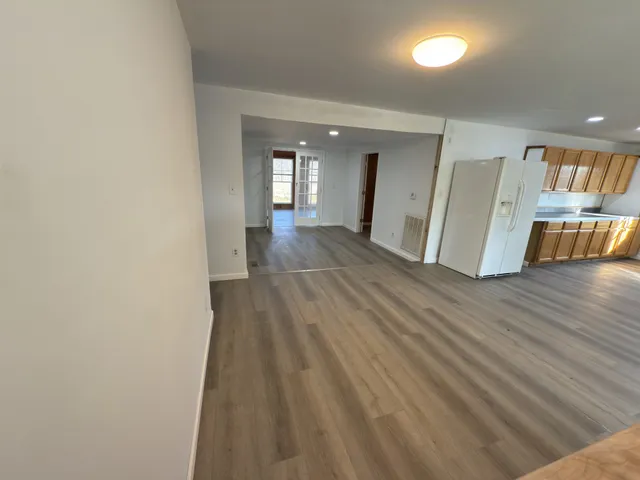 a kitchen with granite countertop white cabinets and sink