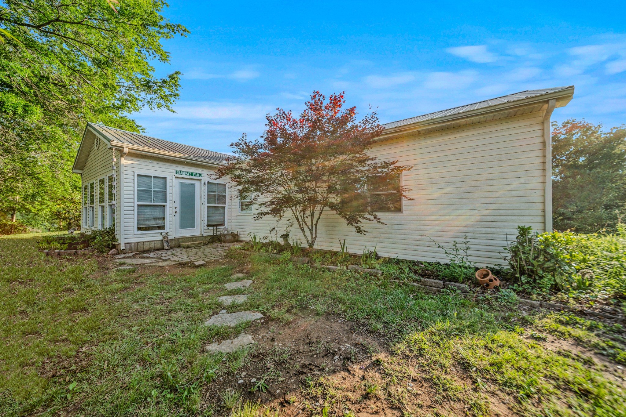 2000 Myers Cove Road McMinnville, TN 37110 - Photo 4 of 76 a backyard of a house with plants and trees