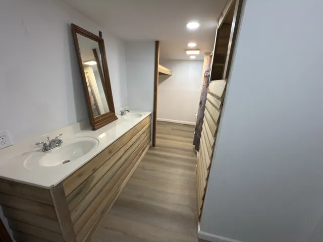 a bathroom with a sink toilet and window