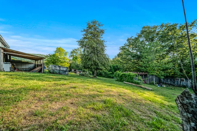 a view of yard with swimming pool and green space