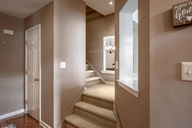 a view of a hallway with wooden floor and windows