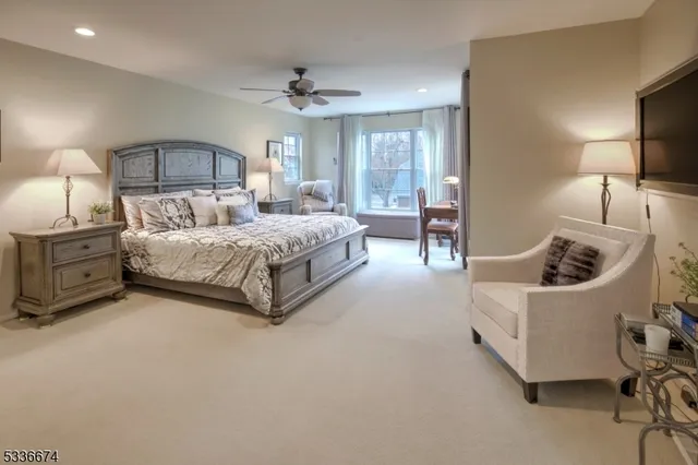 a spacious bedroom with a bed and a chair