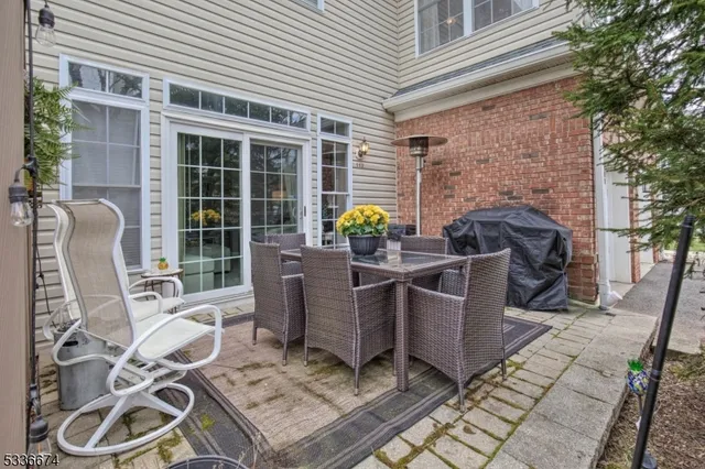 a view of a patio with table and chairs and potted plants