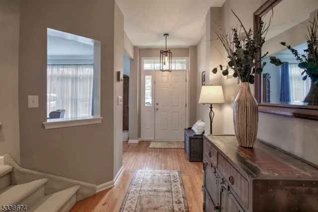 a hallway with a large window and wooden floor