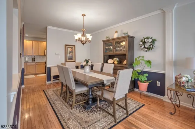 a view of a dining room with furniture wooden floor and chandelier
