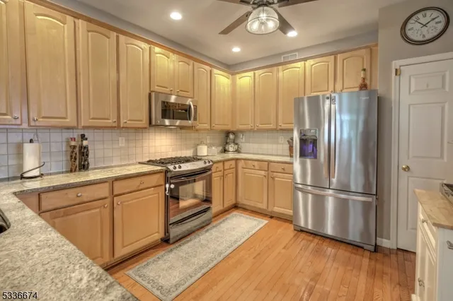 a kitchen with a refrigerator stove top oven and sink