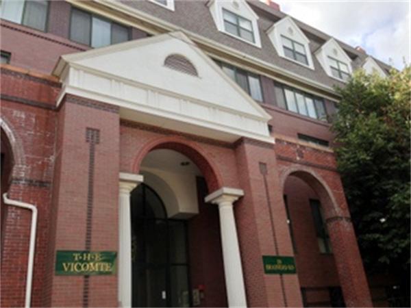 a close view of a house with a door and a car parked