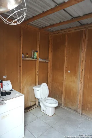 a bathroom with a toilet and shower