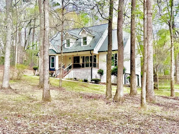 a view of a house with a yard and the trees