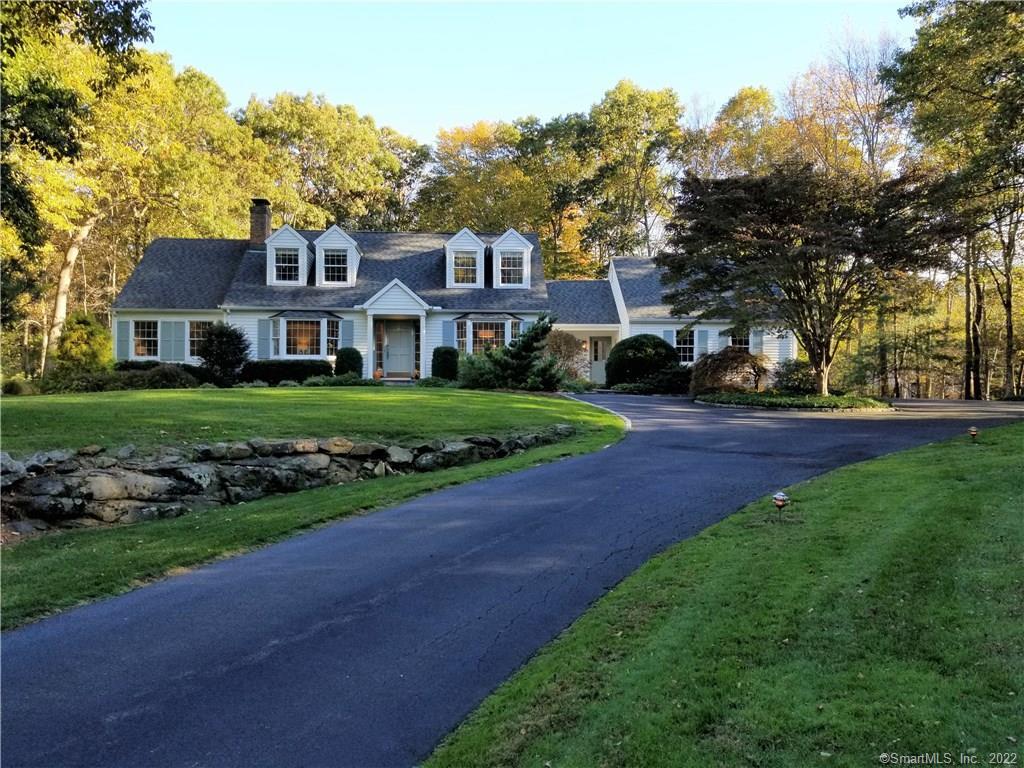 39 Marvin Ridge Place Wilton, CT 06897 - Photo 1 of 1 a front view of a house with a garden and trees