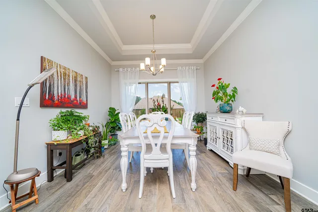 a living room with furniture a chandelier and a fireplace