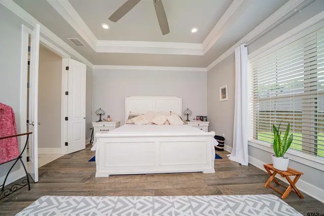 a spacious bedroom with a bed and a window