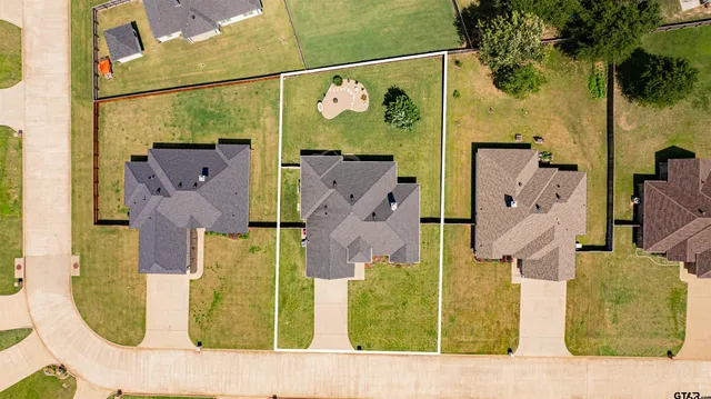 an aerial view of a house with a swimming pool