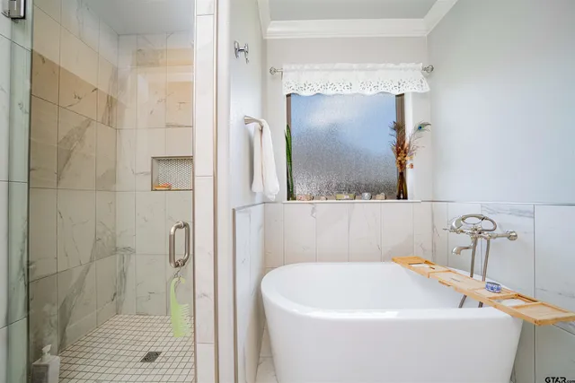 a white bath tub sitting next to a bathroom sink