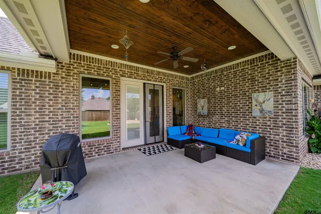 a backyard of a house with a garden and outdoor seating