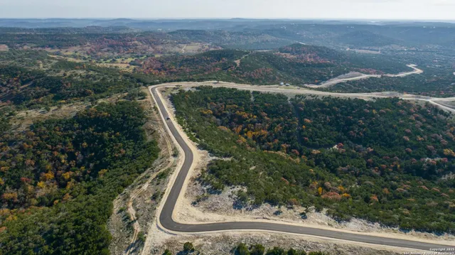 an aerial view of a residential houses and green space