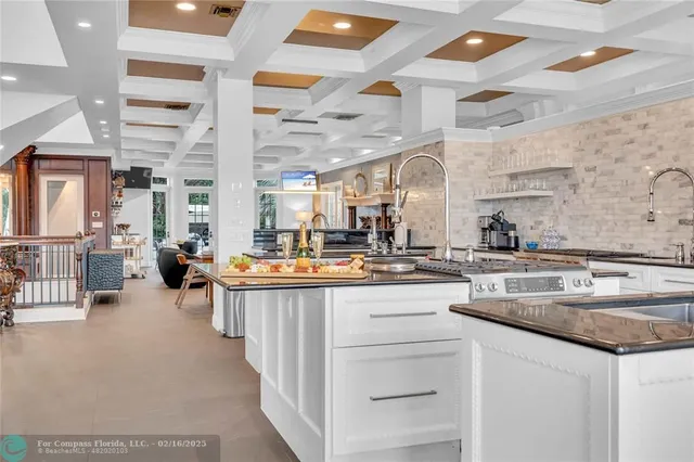 a kitchen with lots of counter space and painting on the wall