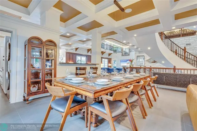 a dining room with stainless steel appliances granite countertop a dining table and chairs with wooden floor