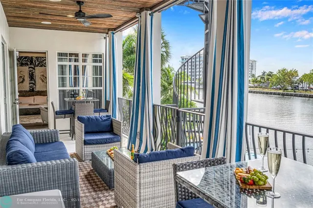 a living room with furniture and a floor to ceiling window