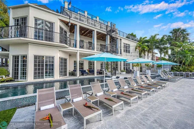 a view of a patio with table and chairs under an umbrella