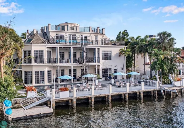 a view of a patio with table and chairs and potted plants