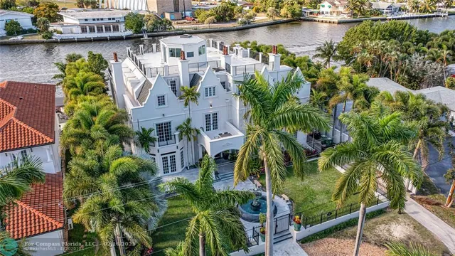 an aerial view of a house with outdoor space and lake view