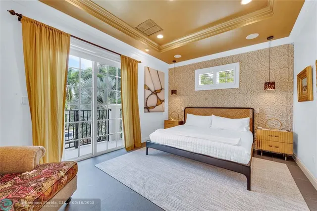 a spacious bedroom with a bed and glass window