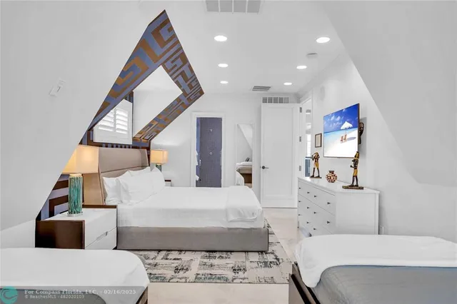 a spacious bedroom with a bed and a large mirror