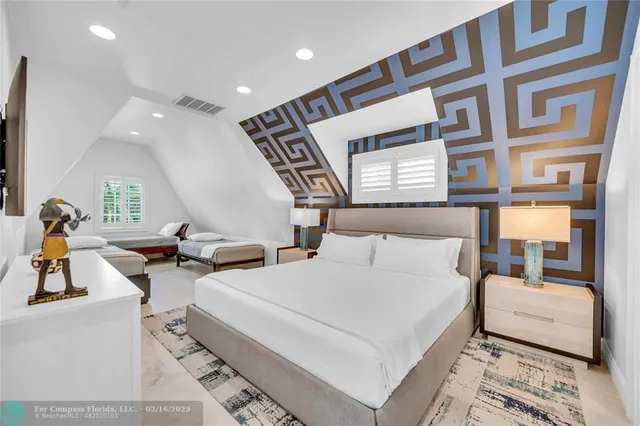 a bedroom with a large bed and a large window