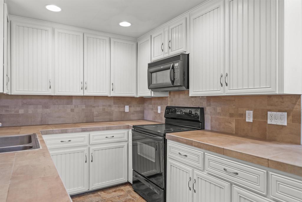 29131 Half Moon Trail Pine Valley, CA 91962 - Photo 18 of 50 a kitchen with white cabinets and white appliances