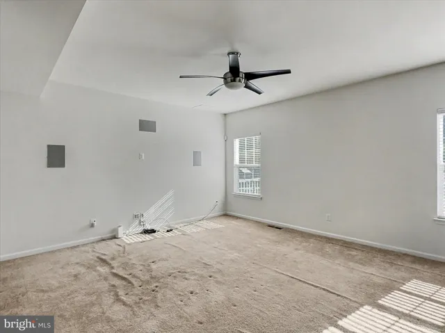 a view of a room with rack and ceiling fan