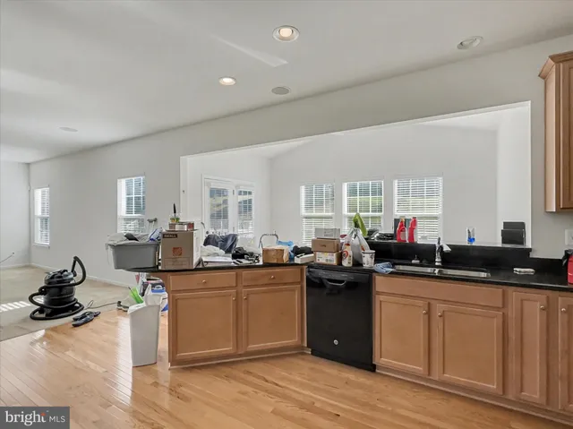 a kitchen with a sink dishwasher stove and cabinets