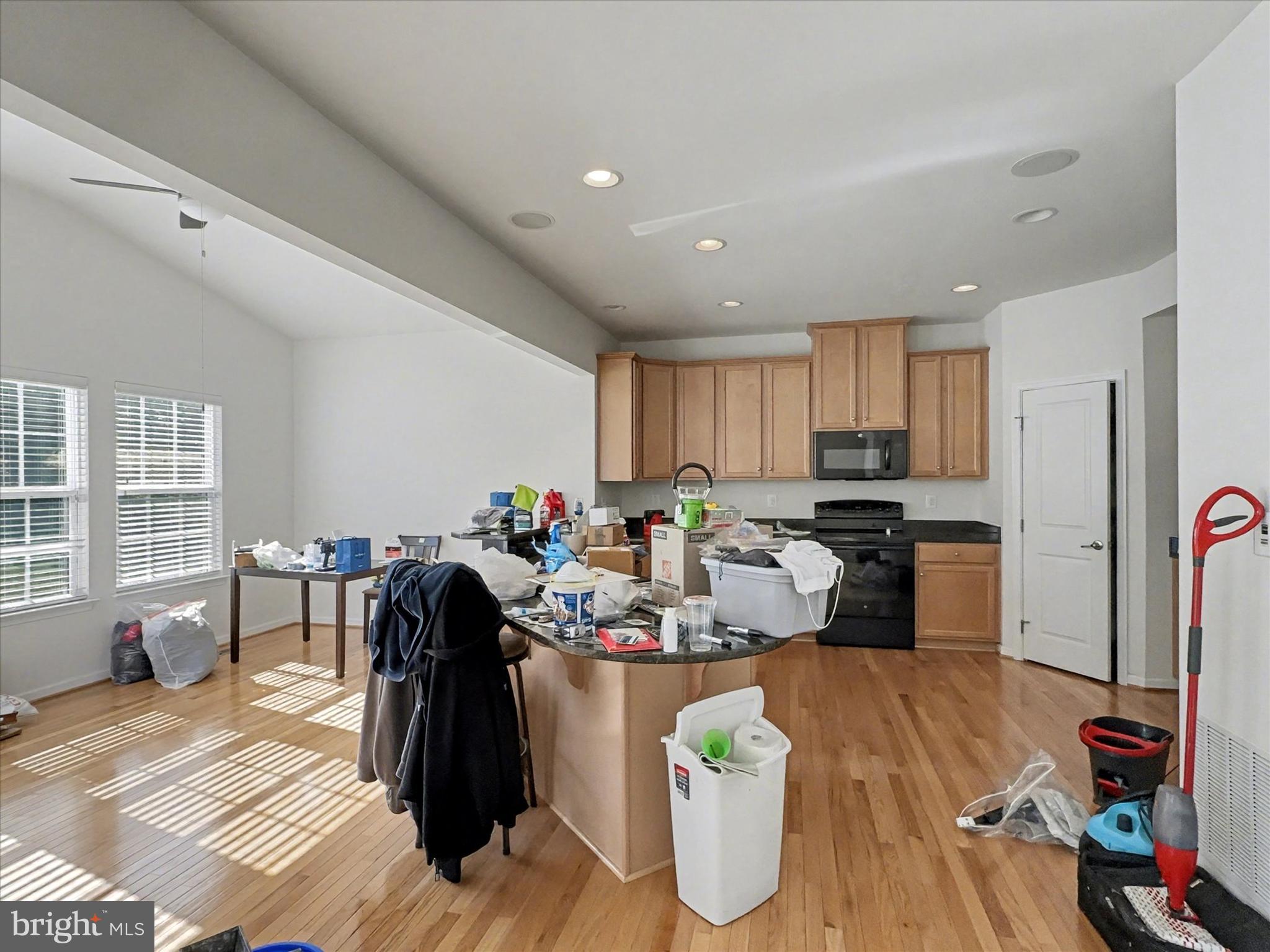 813 Countryside Road Seven Valleys, PA 17360 - Photo 9 of 38 a kitchen with stainless steel appliances kitchen island granite countertop a refrigerator a stove a sink dishwasher and a dining table with wooden floor