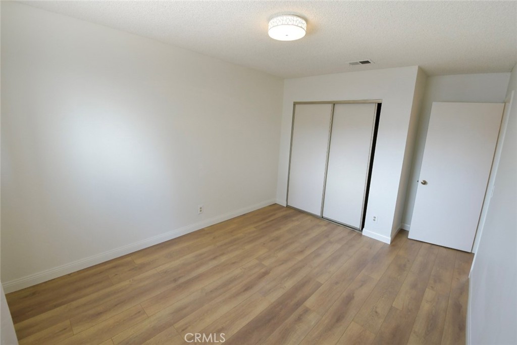 22346 Harbor Ridge Lane, Unit 4 Torrance, CA 90502 - Photo 15 of 34 an empty room with wooden floor