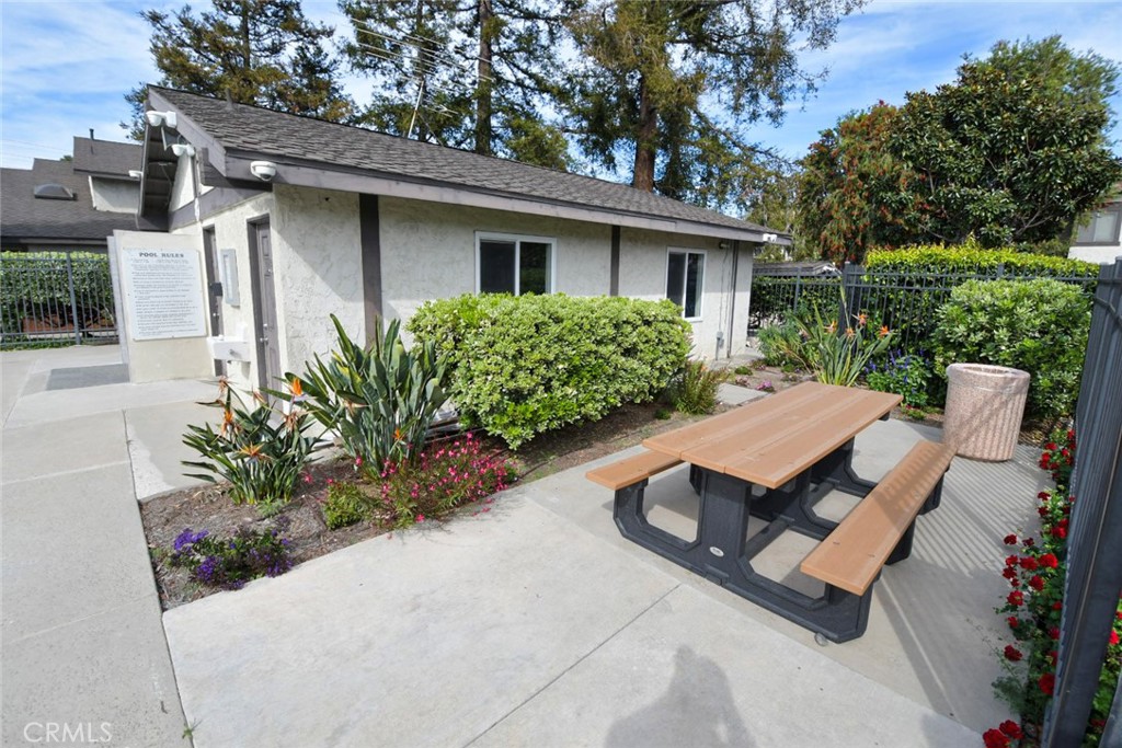 22346 Harbor Ridge Lane, Unit 4 Torrance, CA 90502 - Photo 26 of 34 a view of a patio with table and chairs potted plants and large tree