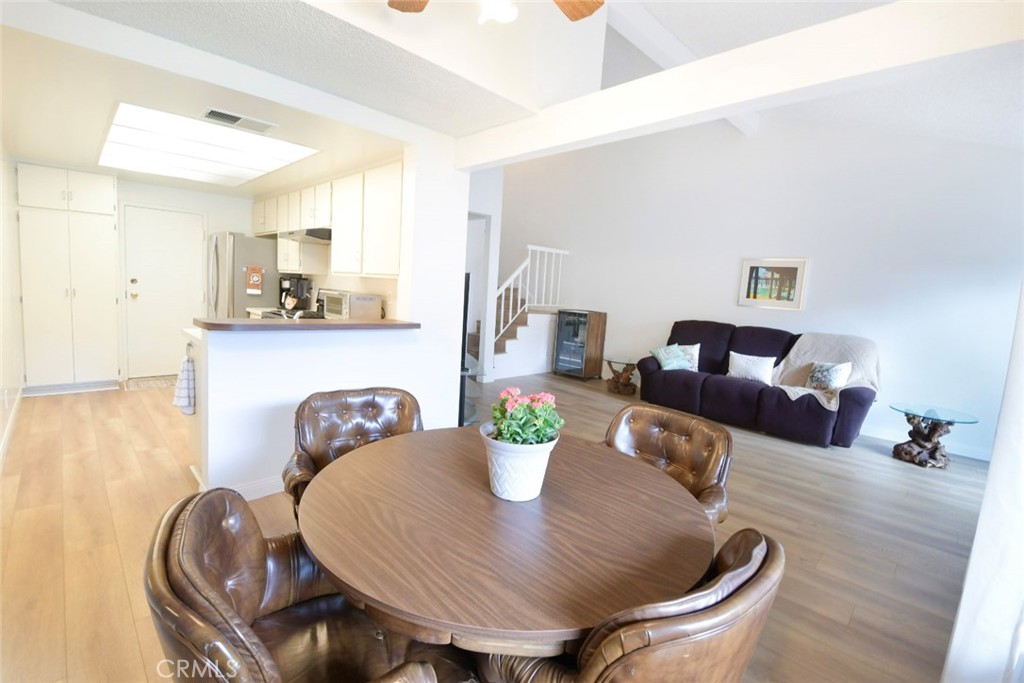 22346 Harbor Ridge Lane, Unit 4 Torrance, CA 90502 - Photo 28 of 34 a view of a dining room with furniture a chandelier and wooden floor