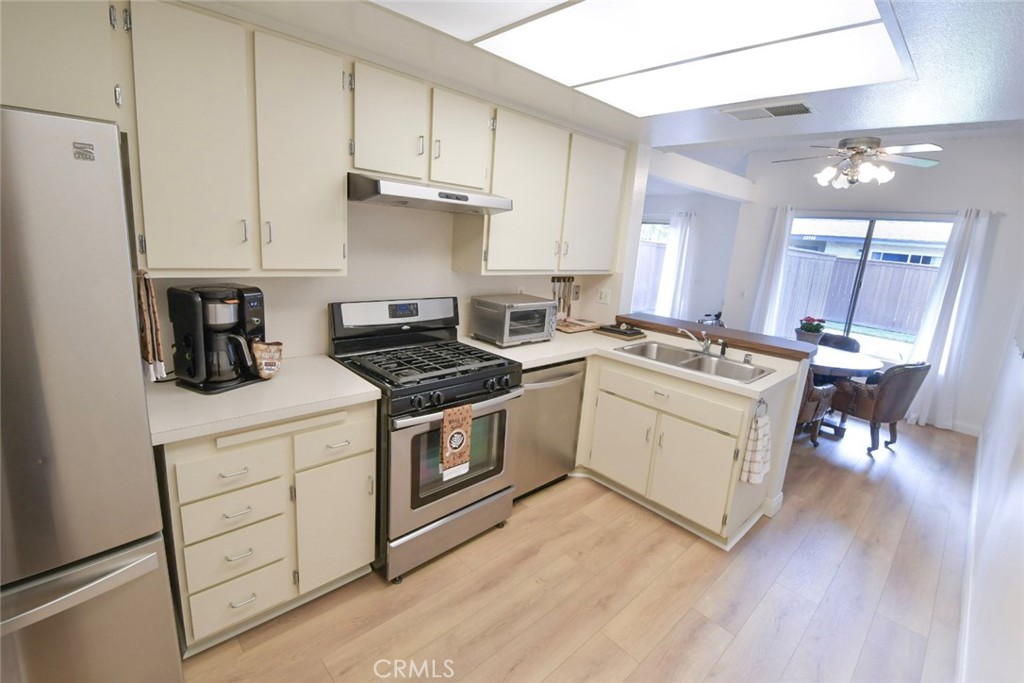 22346 Harbor Ridge Lane, Unit 4 Torrance, CA 90502 - Photo 4 of 34 a kitchen with a sink a stove and cabinets