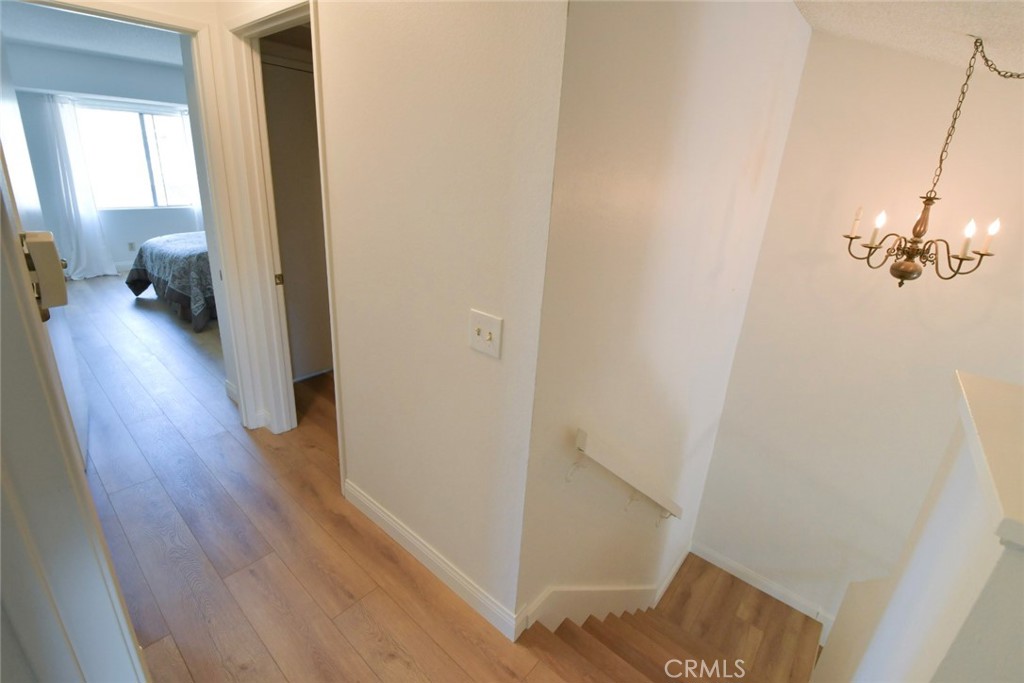 22346 Harbor Ridge Lane, Unit 4 Torrance, CA 90502 - Photo 8 of 34 a view of a hallway with wooden floor and staircase