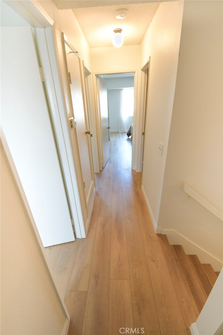 22346 Harbor Ridge Lane, Unit 4 Torrance, CA 90502 - Photo 9 of 34 a view of a hallway with wooden floor and staircase
