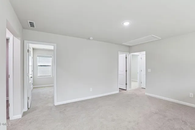 a kitchen with stainless steel appliances kitchen island a white stove top oven and white cabinets