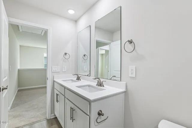 a bathroom with a toilet a sink and a large mirror
