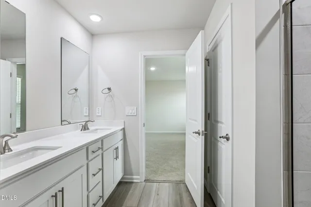 a bathroom with a double vanity sink mirror and double