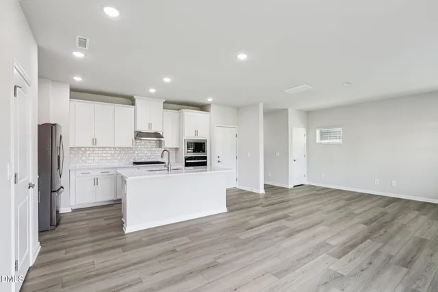 a kitchen with a refrigerator and a counter top space