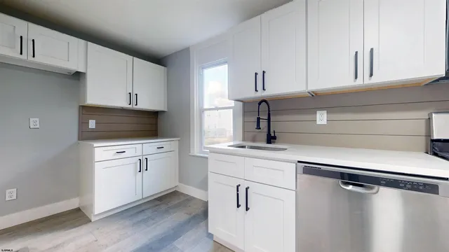 a kitchen with appliances cabinets and a sink