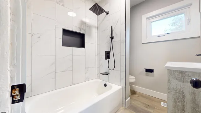 a bathroom with a bathtub and a shower