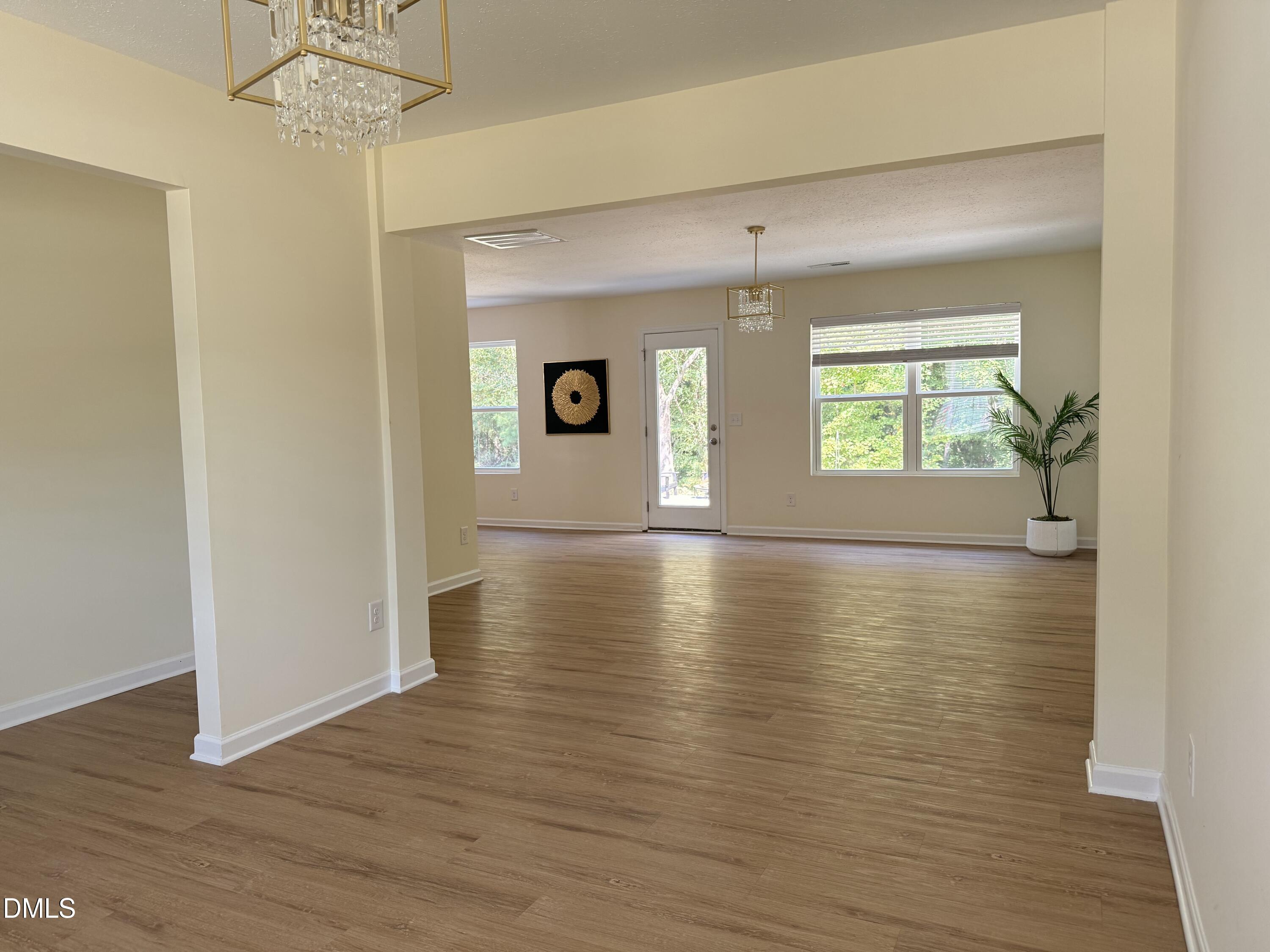 62 West Boulder Road Henderson, NC 27537 - Photo 13 of 34 an empty room with wooden floor and windows