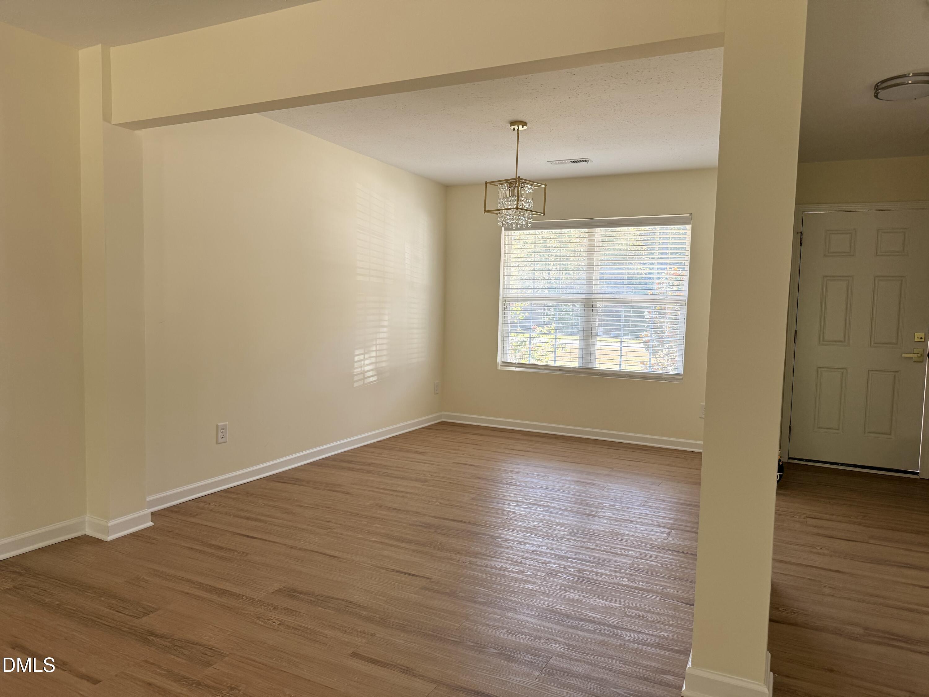 62 West Boulder Road Henderson, NC 27537 - Photo 14 of 34 an empty room with wooden floor and windows