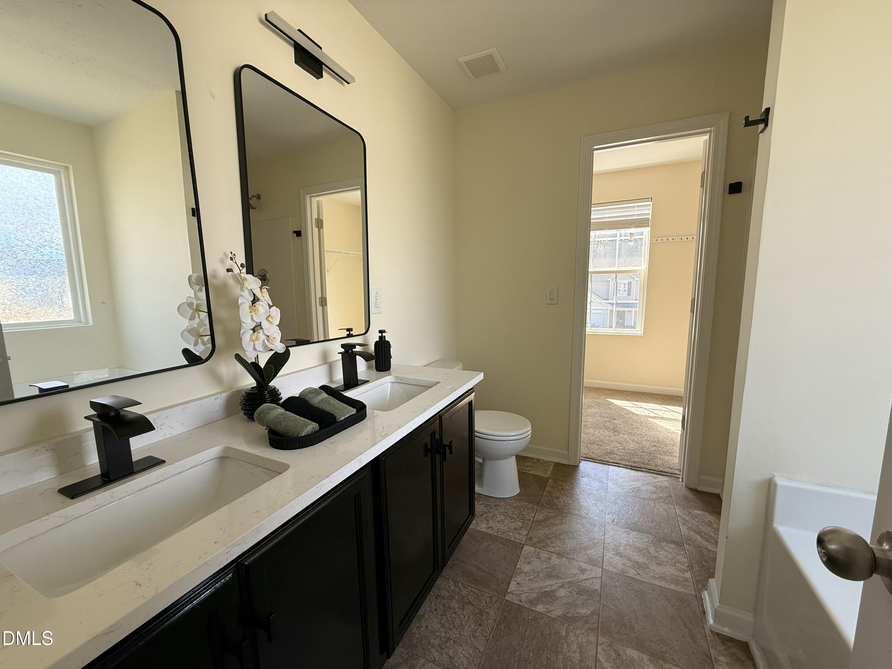 62 West Boulder Road Henderson, NC 27537 - Photo 29 of 34 a bathroom with a sink and a mirror