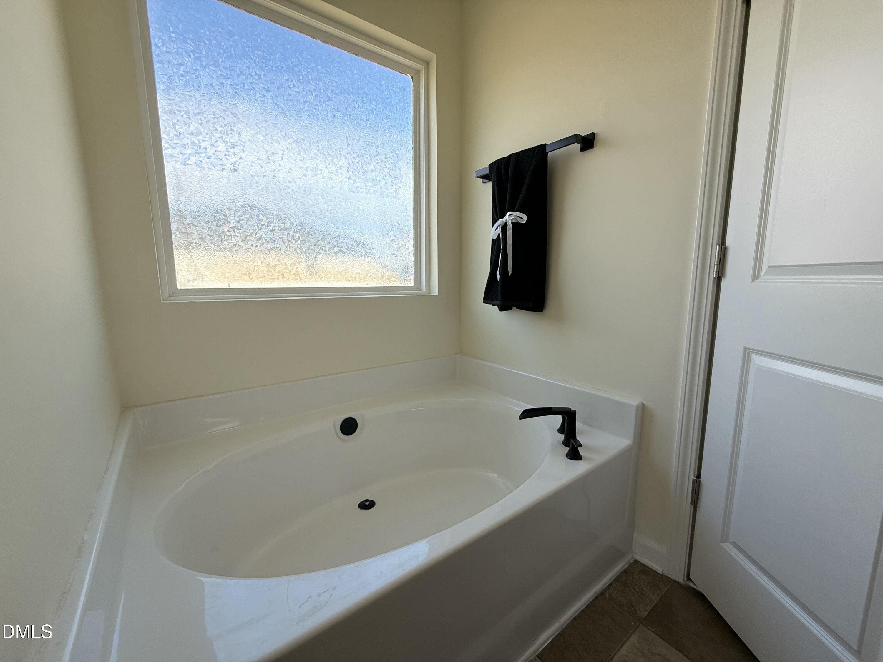 62 West Boulder Road Henderson, NC 27537 - Photo 31 of 34 a bathroom with a tub and a shower