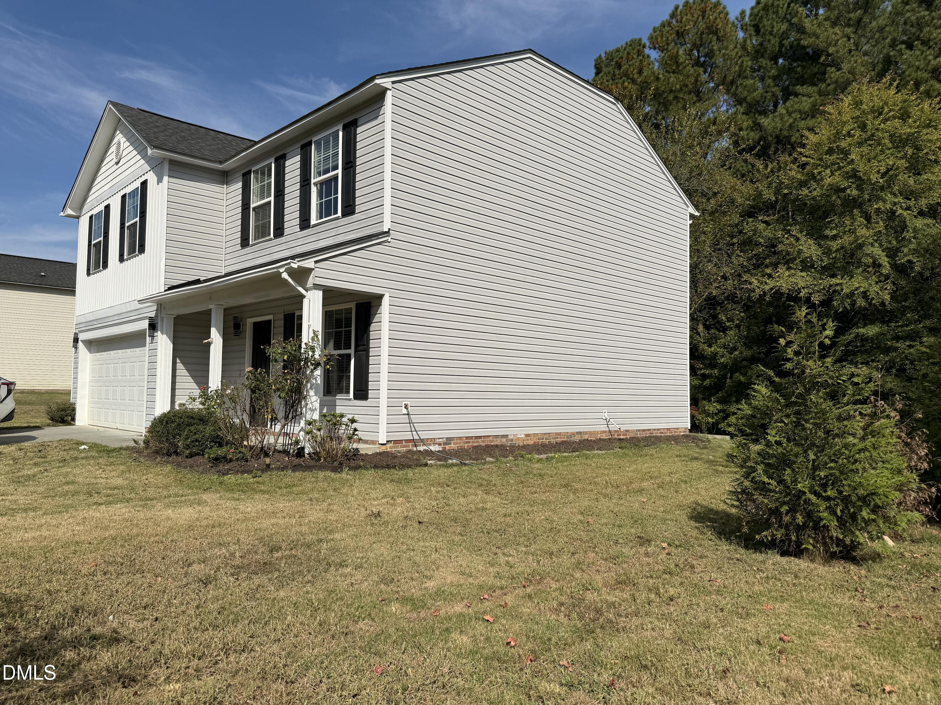 62 West Boulder Road Henderson, NC 27537 - Photo 5 of 34 a front view of a house with garden